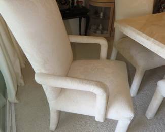 Two dinng chairs with arms.