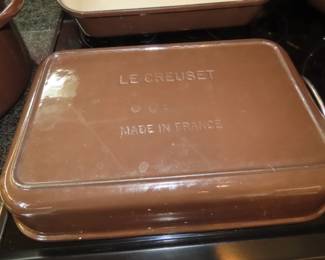 Brown Le Crueset casseroles and dishes.