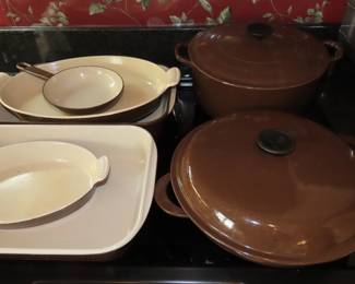 Brown Le Crueset casseroles and dishes.