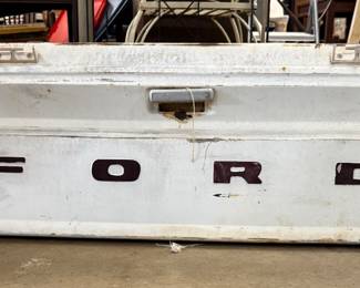 A Ford tailgate, which you could hang in your garage your man cave make it into a bench or use it on an antique Ford truck