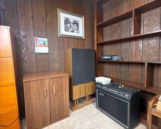 Study or office space with shelving units, audio components, speakers, vinyl records, and framed décor