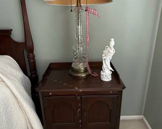 Antique Mahogany Nightstand with Glass Column Lamp and Porcelain Figurine