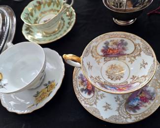 Porcelain Teacup and Saucer Set with Hand-Painted Pastoral Scenes and Gilt Decoration