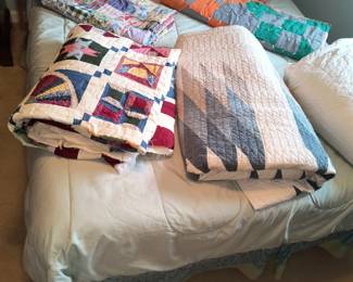Assorted quilts and quilt tops