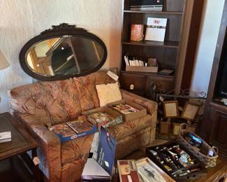 Paper dolls, paper items, comic books on love seat! 