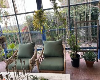 Two of four green upholstery bamboo rattan arm chairs 