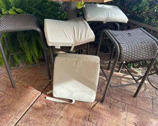 Four bar stools for patio, four seat cushions, one stool has break in top weaving