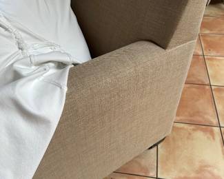 Sofa with slipcover pulled back to see the linen fabric upholstery 