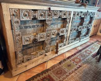 Sideboard has doors held in place by turning wood