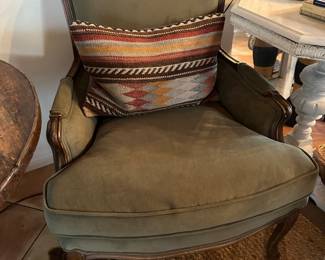 One of two olive velveteen arm chairs