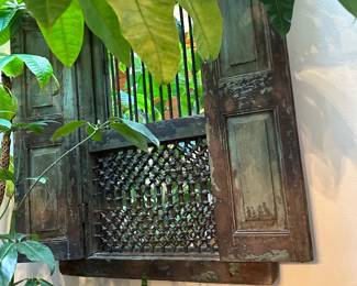 Wall mirror with intricate carving, folding doors, larger than appears 