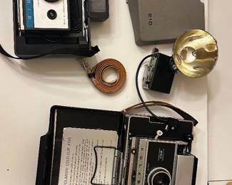 	#107	RA	Two vintage Polaroid cameras with accessories model 210 and 250. -untested	 $ 25.00 		