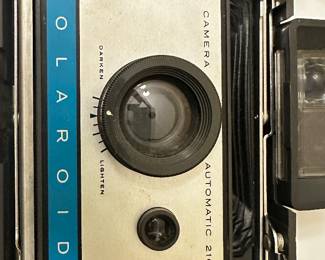 	#107	RA	Two vintage Polaroid cameras with accessories model 210 and 250. -untested	 $ 25.00 		