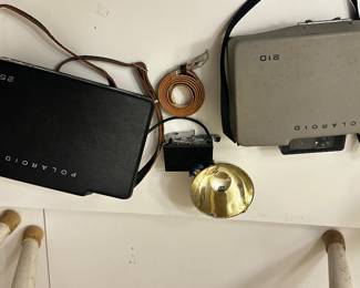 	#107	RA	Two vintage Polaroid cameras with accessories model 210 and 250. -untested	 $ 25.00 		