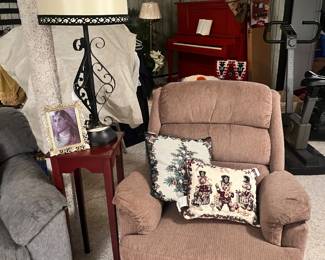 Brown recliner, plant stand, and iron table lamp
