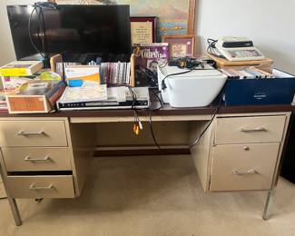 Metal desk, television, printer, VHS, CDs, and cassette tapes