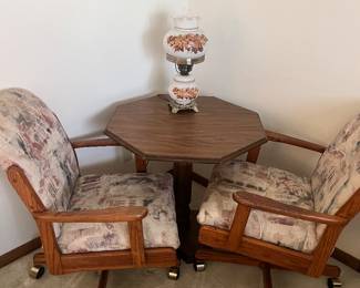 Two swivel rolling chairs and octagon table