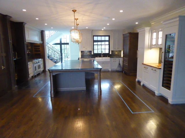 The Craftsman Style Kitchen Cabinets are White and Finished Oak, Doors and Drawers are Soft Touch all Drawer are made of Walnut. The very large Island, 10′ 8′ X 67 1/2′ is Soap Stone Boarder around Quartz inside with a 1/4″ Brass inlaid. Shaws Lancaster 39-1/2″ Farmhouse Double Basin Fireclay Kitchen Sink and Shaws Lancaster 15″ Undermount Single Basin Fireclay Kitchen / Bar Sink with Kohler Polished Nickel Kitchen Faucets. There’s Sub-Zero 36″ Paneled Refrigerator and Sub-Zero 27″ Paneled Freezer. The homeowner is keeping the Sub-Zero Wine Refrigerator, the Paneled Door goes with the Cabinets. Also included with the purchase of the kitchen is the 48″ Wolf Range, Exhaust Hood, 2 Miele Dishwashers, Wolf Convection Steam Oven and Disposal. Footprint of kitchen 20’w x 22’l. Homeowners are also keeping handles on door and drawers. Footprint 20’w x 22’l. Cabinets & Appliances