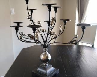 Ornate dark wood and silver colored candle holder