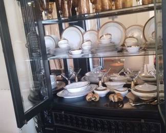 Noritake china inside dark wood china hutch