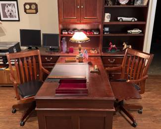 2 sided desk with 2 desk chairs, book case, filing cabinet, and computer desk