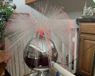 Rotating fiberoptic lamp with several extra wands