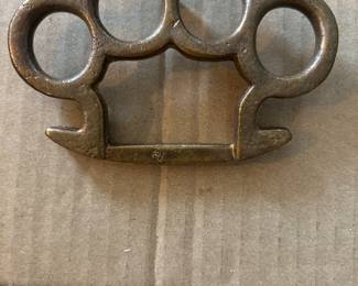 Brass knuckles belt buckle