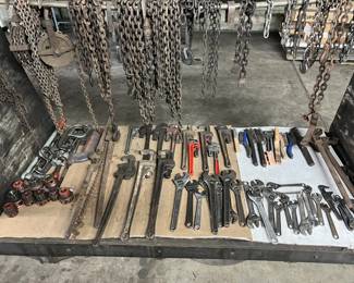 pipe wrenches, smaller wrenches, chains, brushes