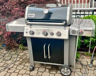 WEBER GENESIS II GRILL..THE HOOD IS DENTED THANKS TO THE TORNADO BUT THAT DOESNT HURT ITS PERFORMANCE!