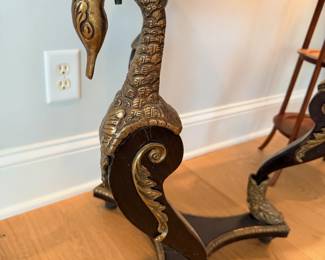 Closeup ornate bronze swan leg detail antique table