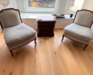 Pair of upholstered slipper chairs with wood trim