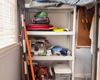 Storage closet with camping gear, household items, and supplies