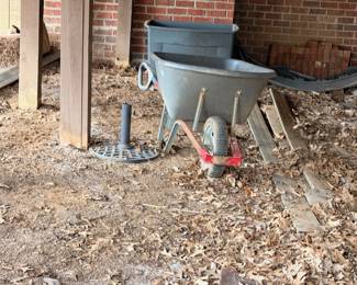 Wheelbarrow, galvanized tub, and outdoor garden tools