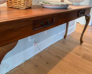 French country console table with woven basket and lamp