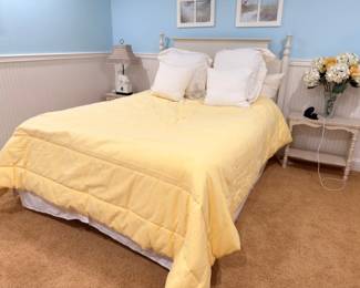 Queen bed with white headboard, nightstands, and lamps