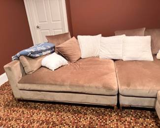 Tan upholstered sectional sofa with throw pillows