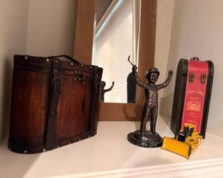 Bronze figurine, vintage trunk, and collectible decor