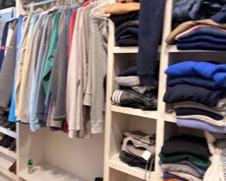 Men's clothing closet, shirts and folded items