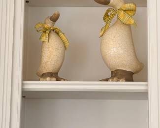 Pair of decorative duck figurines with bows