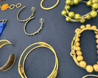 Gold hoop earrings, bangles, and beaded bracelets collection