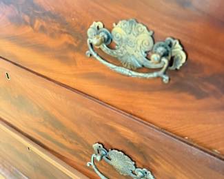 Antique mahogany dresser with ornate brass drawer pulls