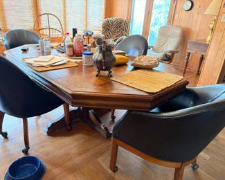 Oak dining table with black vinyl swivel chairs set