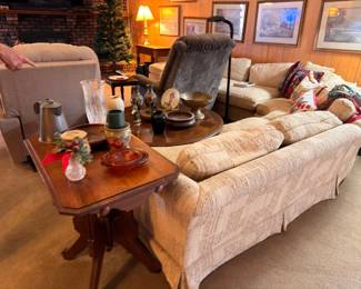 Living room with sofa, recliner, coffee table, lamps, and framed art