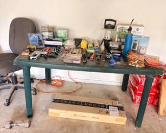 Workbench with assorted hand tools and hardware