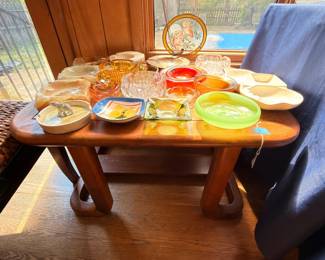 Vintage colored glassware, amber glass, red glass, green plate on wood table