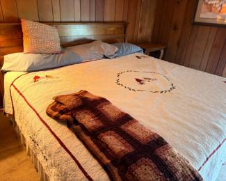 Antique wooden bed with handmade quilt bedspread