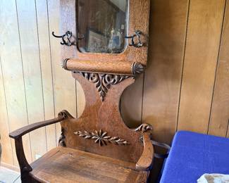 Antique Victorian oak hall tree with mirror, hooks, and seat