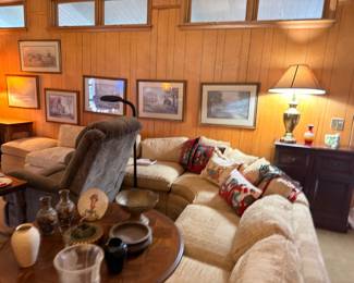 Living room sofa with throw pillows, end table, lamp, and gallery wall art