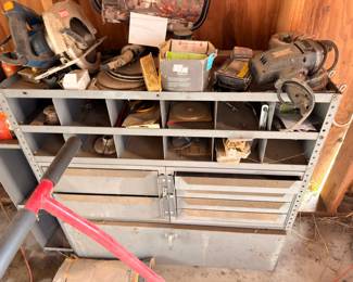 Metal parts bin with power tools, grinder, and hardware