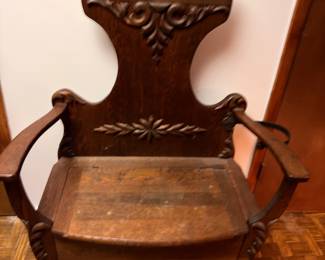 Antique carved wood hall chair with ornate crest back